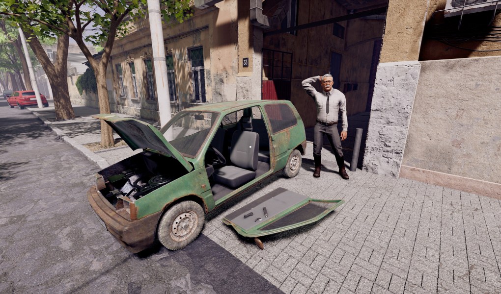 A distressed car dealer stands next to a broken-down vehicle in a city street.