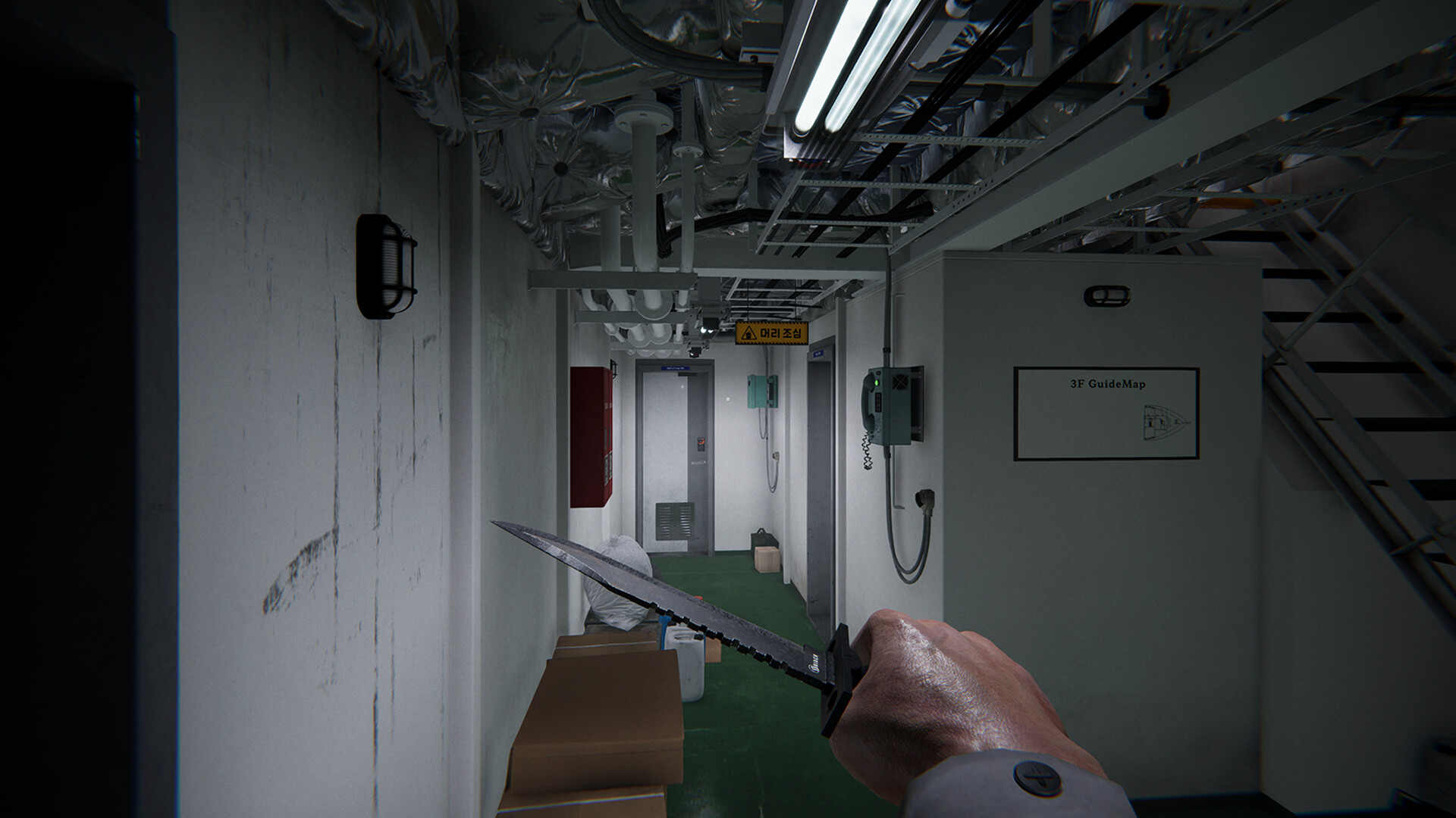 First-person view of a character holding a knife in a dimly lit ship corridor.