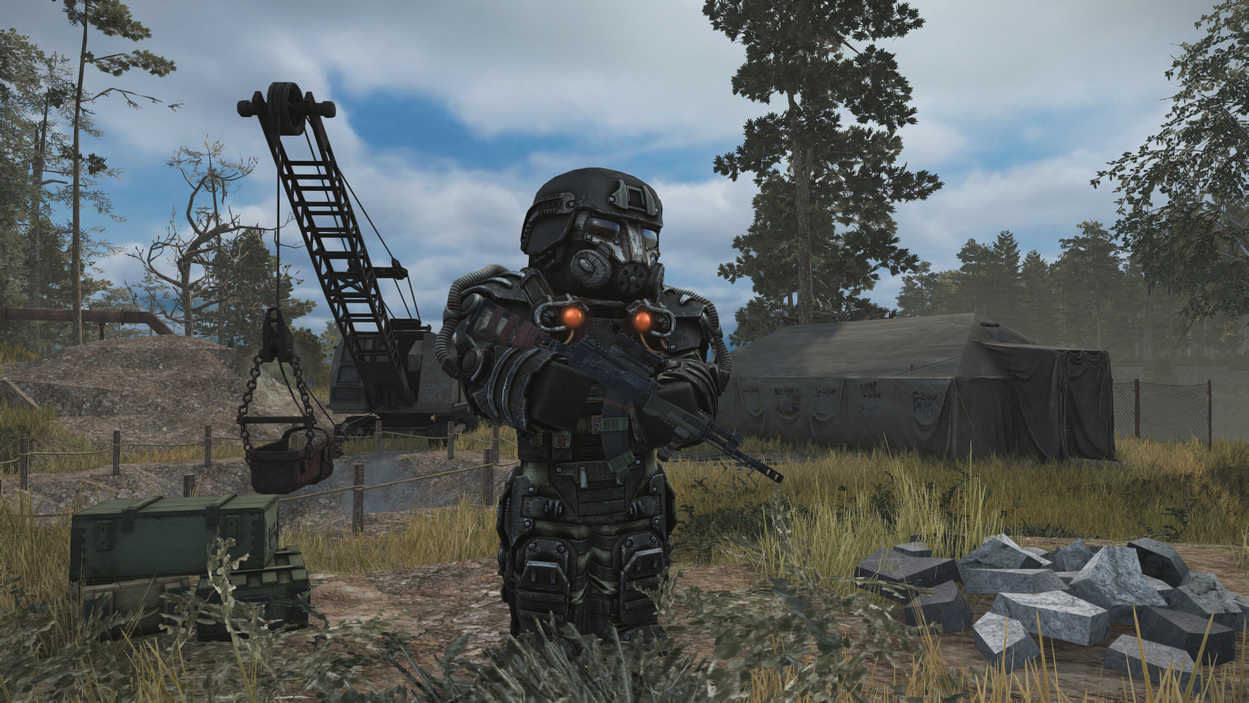 Armored character in STALCRAFT: X standing in a rugged landscape