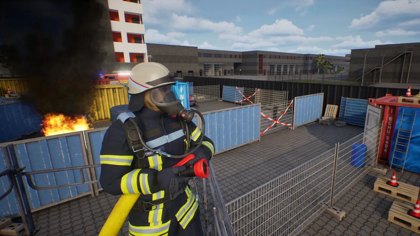 Firefighter in action at a simulated emergency scene with smoke and fire.