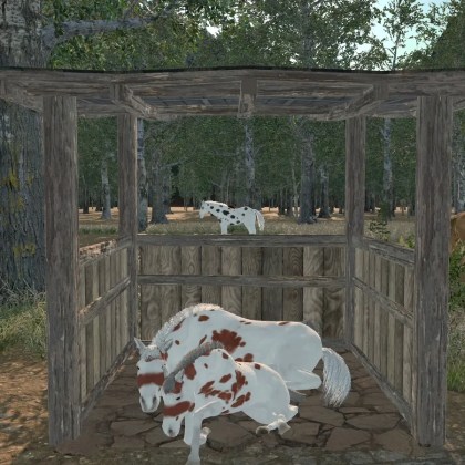 A wooden horse pen in a lush medieval forest setting with horses grazing nearby.
