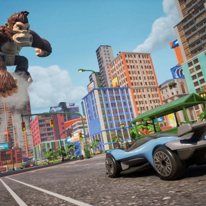 Exciting scene from HOT WHEELS™ Infinite Rush featuring a giant character and a sleek race car.